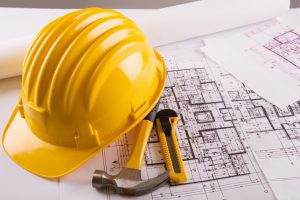 blueprint for construction work with helmet and tools